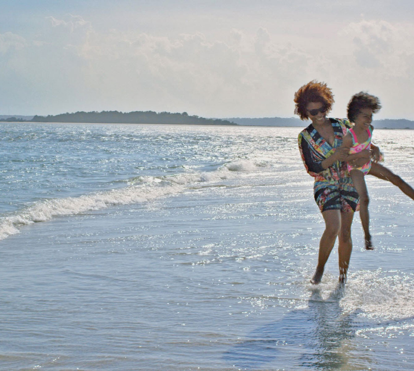 African American female with her daughter playing on the shores of Myrtle Beach.